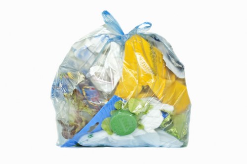 Skip hire truck at a residential driveway in Uxbridge