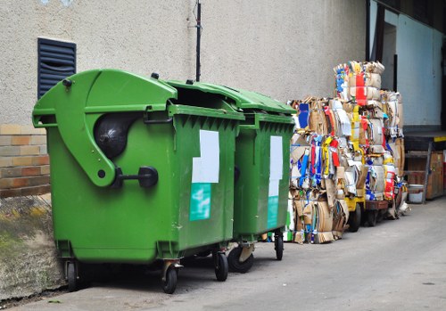 Workers wearing PPE while handling waste at a site